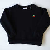 Classic black organic cotton children's sweatshirt, garment-dyed for exceptional softness with a retro look, featuring a vibrant embroidered strawberry, handcrafted in the USA by Colorful Bunch's environmentally conscious children's clothing line.