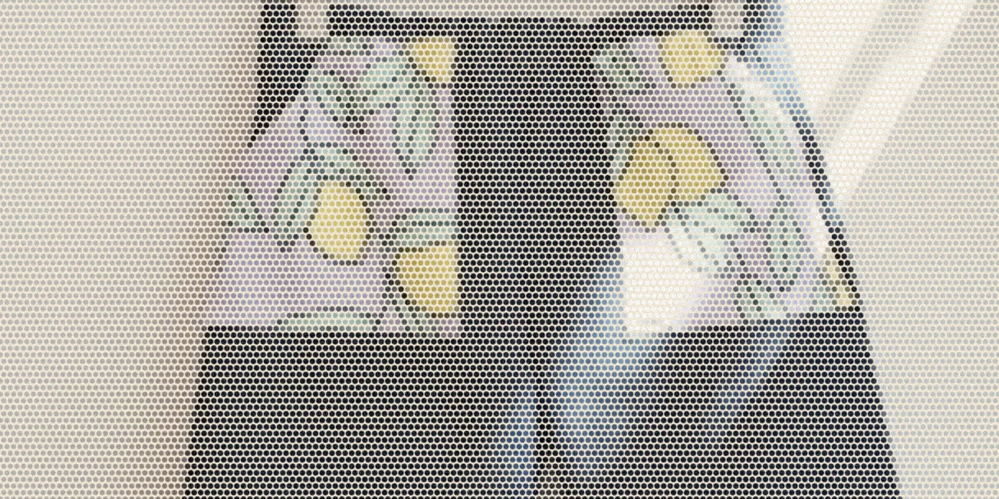 Kids denim jeans hanging from a wooden hanger; a bold Paper halftone photo treatment