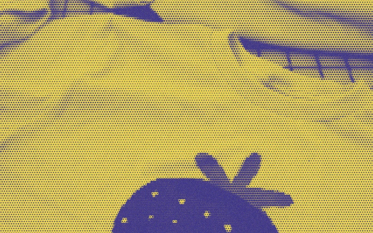 Small batch of strawberry tees laid across the studio worktable; a bold Paper halftone photo treatment