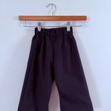 Dark striped children’s pull-on pants on a wooden hanger