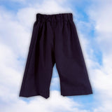 Sample dark pinstripe children’s pull-on pants with an elastic waist on a blue sky background