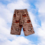 Sample tan children’s pull-on pants with a duck and hunting dog print on a blue sky background
