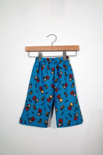Kids’ pull-on pants in construction crew, shown hanging from a wooden hanger.