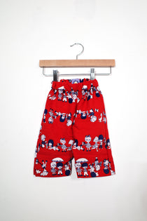 Kids’ pull-on pants in parade, shown hanging from a wooden hanger.