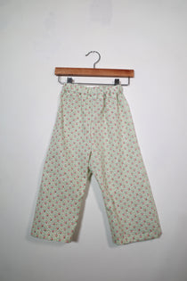 Kids’ pull-on pants in rosebud floral, shown hanging from a wooden hanger.