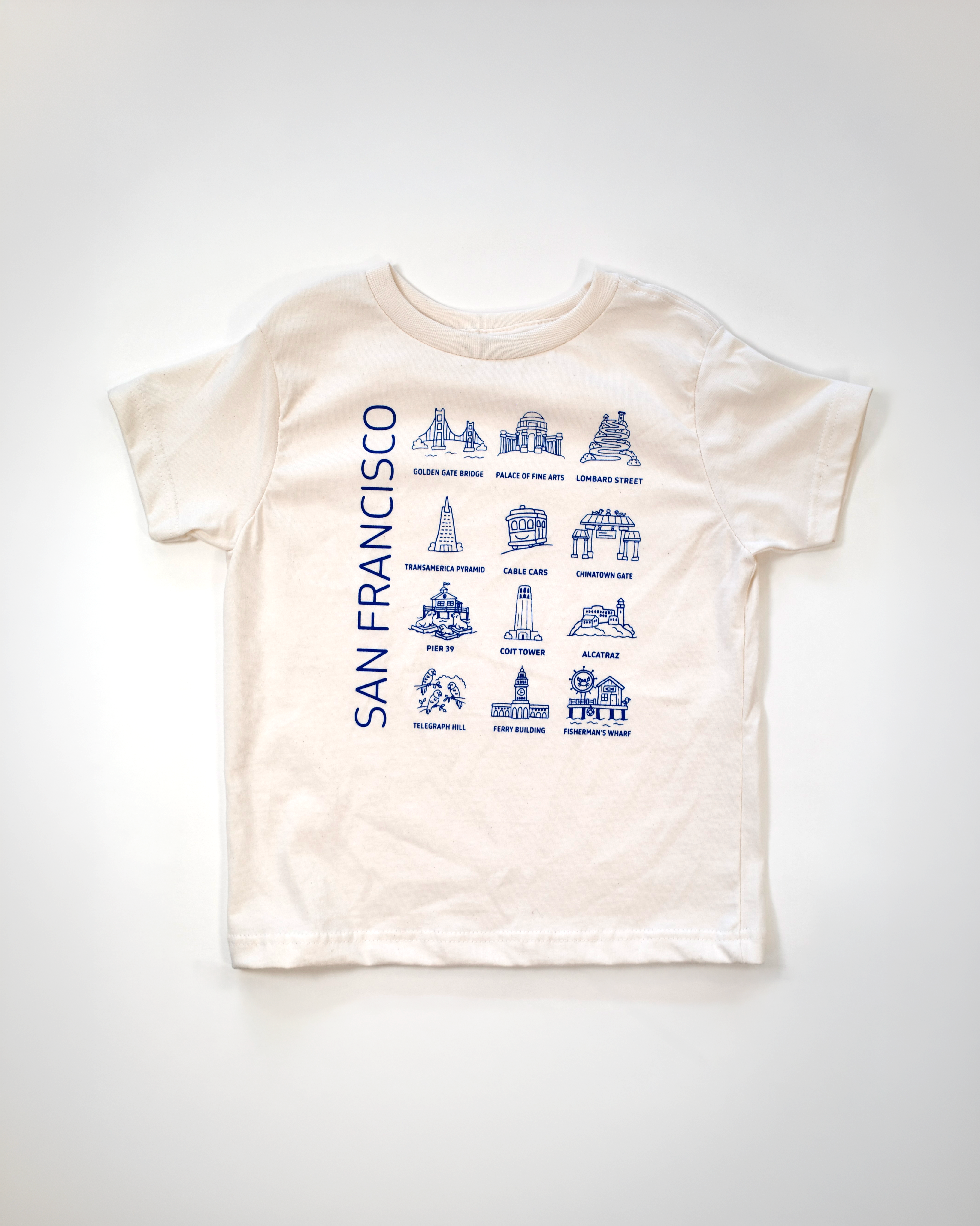 Undyed kids tee printed in blue with San Francisco landmarks, laid flat on a white background.